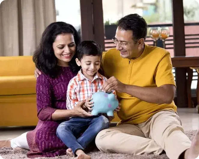 Parents helping their child put savings into a piggy bank
